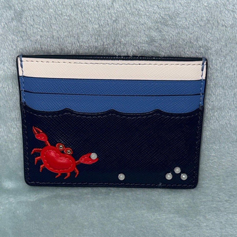 kate spade New York Pinch Me Crab Pearl Beach Blue small slim card holder.